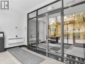 Hamilton (Beasley) condo for rent - A glass door entrance to a building with a sign that says REALTOR.