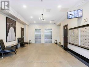 Hamilton (Beasley) condo for rent - A hallway with a bench, a television, and a wall of windows.