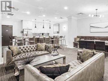 Hamilton (Beasley) condo for rent - A living room with a grey couch and a coffee table.