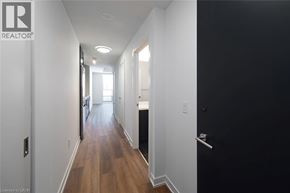 Kitchener condo for rent - A long hallway with a door on the right.