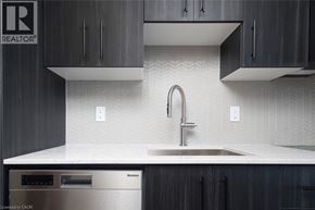 Kitchener condo for rent - A modern kitchen with a sink and a dishwasher.