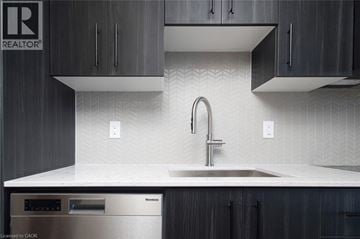 Kitchener condo for rent - A modern kitchen with a sink and a dishwasher.