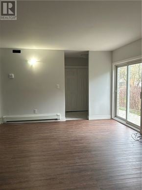 Sudbury apartment for rent - A view of a patio through a sliding glass door.