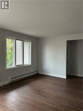 Sudbury apartment for rent - A room with a window and wooden floors.