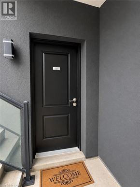 Niagara Falls townhouse for rent - A black door with a glass window on the left and a welcome mat on the right.