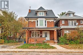 Hamilton (St. Clair) apartment for rent - A two-story house with a brick facade and a white door.