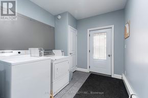Hamilton (St. Clair) apartment for rent - A bathroom with a toilet, sink, and mirror.