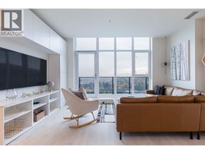 Coquitlam apartment for rent - A modern living room with a large window and a view of the city.