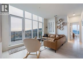 Coquitlam apartment for rent - A living room with a brown couch and a white chair.