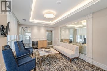 Mississauga (Fairview) condo for rent - A living room with a blue chair and a white sofa.