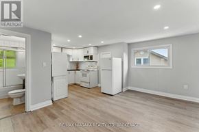 Welland (Lincoln/Crowland) apartment for rent - A well-lit kitchen with white appliances and wooden flooring.