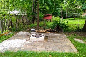 Meaford apartment for rent - A backyard with a fire pit and a fence.