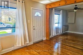 Meaford apartment for rent - A room with wooden floors and a ceiling fan.
