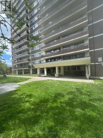 Toronto (Oakwood Village) house for rent - A large apartment building with a grassy area in front.