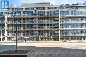 Toronto (Niagara) condo for rent - A large, modern building with a lot of windows and balconies.