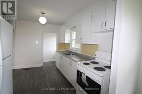Toronto (L'amoreaux) apartment for rent - A kitchen with white cabinets and a white stove top oven.