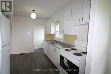 Toronto (L'amoreaux) apartment for rent - A kitchen with white cabinets and a white stove top oven.
