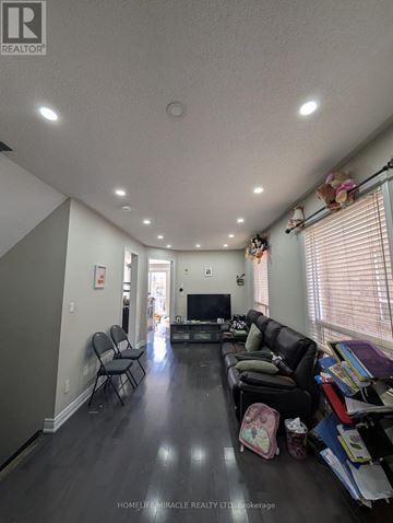 Mississauga (East Credit) apartment for rent - A living room with a black couch and a television.