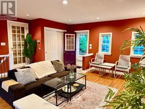 St. Catharines (Vine/Linwell) apartment for rent - A living room with a black leather couch and a glass coffee table.