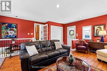St. Catharines (Vine/Linwell) apartment for rent - A living room with a black leather couch and a glass coffee table.