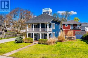 Fort Erie (Lakeshore) apartment for rent - A blue house with a white porch and a red house in the background.