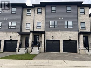 Cambridge townhouse for rent - A building with a sign that says "HOMELIFE MIRACLE REALTY LTD, Brokerage" in front of it.