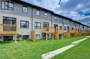 Cambridge townhouse for rent - A row of modern townhouses with balconies and a grassy front yard.