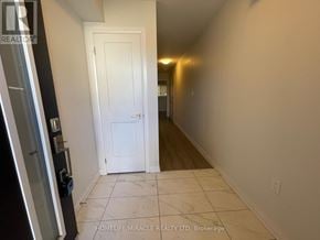 Cambridge townhouse for rent - A hallway with a white door and tiled floor.