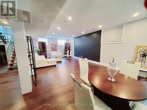 Toronto (Long Branch) apartment for rent - A dining room with a wooden table and white chairs.