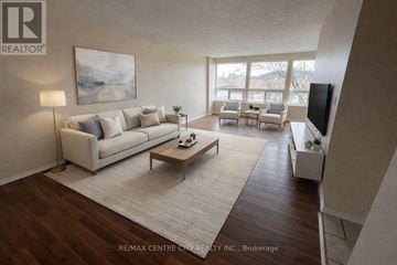 London East (East D) condo for rent - A living room with a couch, a coffee table, and a painting on the wall.