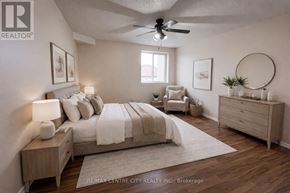 London East (East D) condo for rent - A bedroom with a bed, nightstand, and chair.
