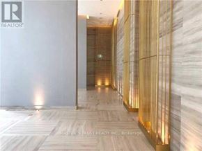 Toronto (Church-Yonge Corridor) condo for rent - A hallway with a marble floor and gold-painted walls.