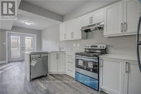 Oshawa (Donevan) duplex for rent - A kitchen with white cabinets and a fridge.