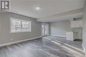 Oshawa (Donevan) duplex for rent - A spacious room with a grey floor and white walls.