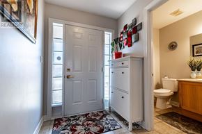 St. Catharines (Rykert/Vansickle) apartment for rent - A bathroom with a white door, a white cabinet, and a white toilet.
