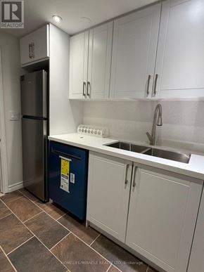 Richmond Hill (Jefferson) apartment for rent - A kitchen with white cabinets and a blue bin.