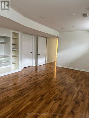 Richmond Hill (Jefferson) apartment for rent - A room with wooden floors and white walls, with a realtor logo in the corner.
