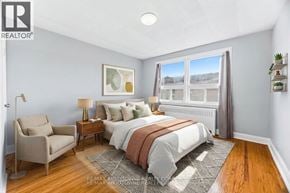 Oakville (Cp College Park) apartment for rent - A bedroom with a bed, chair, and window.