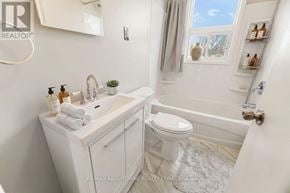 Oakville (Cp College Park) apartment for rent - A white bathroom with a tub, toilet, and sink.