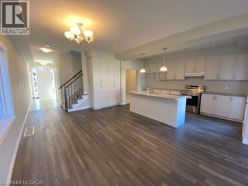 Kitchener apartment for rent - A spacious kitchen with a dining area and a staircase.