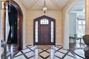 Toronto (Banbury-Don Mills) apartment for rent - A large wooden door with a glass panel is the centerpiece of a foyer with a black and white checkered floor.