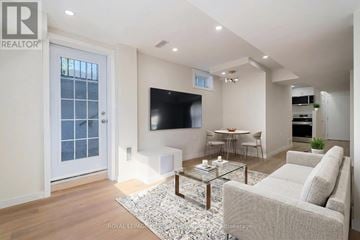 Milton (Cb Cobban) apartment for rent - A living room with a glass coffee table and a white couch.