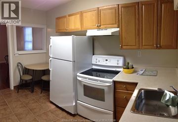 Windsor apartment for rent - A kitchen with a white refrigerator and stove.