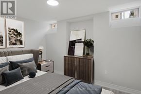 Whitchurch-Stouffville (Stouffville) apartment for rent - A bedroom with a bed, nightstand, and a painting on the wall.