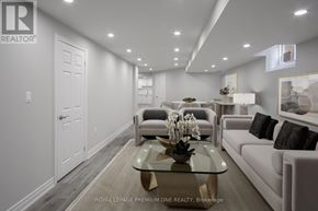 Whitchurch-Stouffville (Stouffville) apartment for rent - A well-lit, modern living room with a glass coffee table and a white sofa.