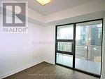 Toronto (Bay Street Corridor) condo for rent - A room with a sliding glass door and a window.