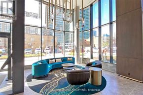 Toronto (Willowdale East) condo for rent - A modern waiting area with a large window and a view of the city.