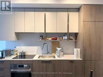 Toronto (Willowdale East) condo for rent - A kitchen with wooden cabinets and a sink.