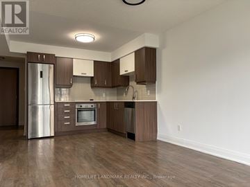 Markham (Unionville) condo for rent - A kitchen with brown cabinets and a stainless steel refrigerator.