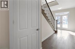 Thorold apartment for rent - A white door is on the left of a staircase.